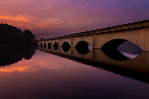 Ashopton viaduct reflected in Ladybower Reservoir at sunrise - Peak District Landscape Photography