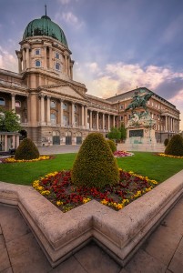 Buda Castle at sunset with some lovely flowers and rays of light coming from the sun. Buda Castle, Budapest Hungary.