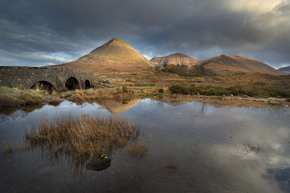 The iconic mountains of Sligachan reflected in a small lochan by the old bridge. Despite the strong winds elsewhere this small lake was perfectly still allowing for some great reflections.