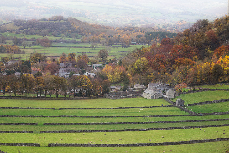 View down over the fields towards the picturesque village of Castleton, taken from the slopes of Winnats Pass. I've attempted this image several times but never had the right conditions. This time though the Autumn colours were at their peak and there was some lovely lingering mist in the valley beyond. Derbyshire, Peak District National Park.