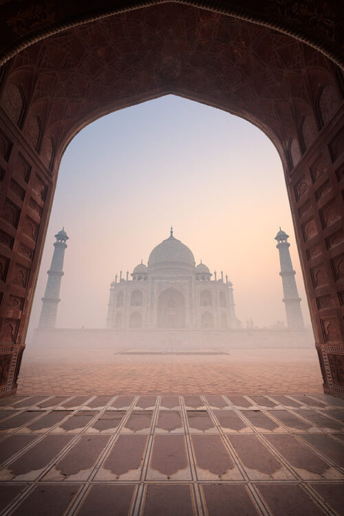 Taj Mahal Mosque. Taj Mahal viewed from inside one of the mosques archways at sunrise, Agra, Uttar Pradesh, India.